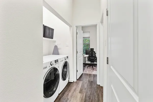 a view of a hallway with washer and dryer