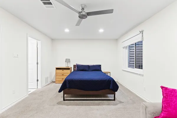 a bedroom with a bed and window