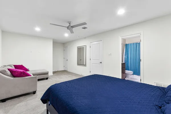 a bedroom with a bed and a couch