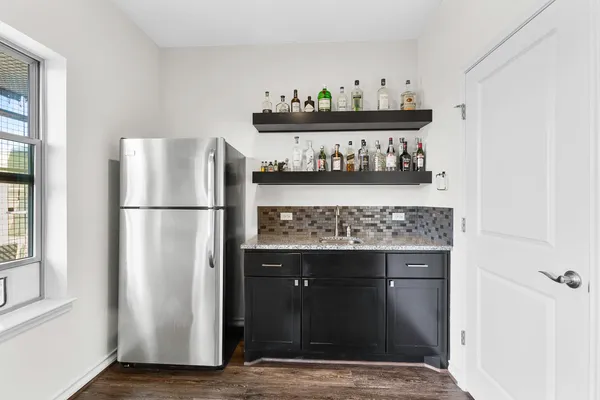 a kitchen with a refrigerator and a stove