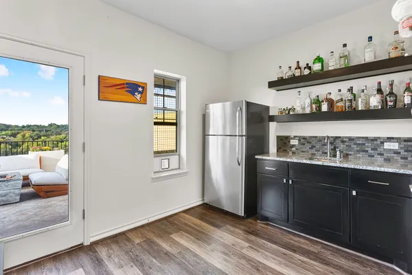 a kitchen with stainless steel appliances granite countertop a refrigerator and a stove