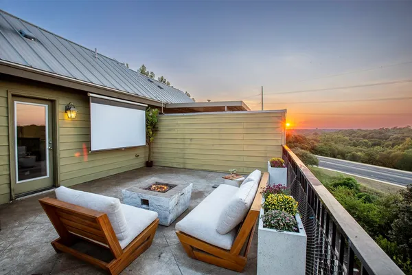 a terrace with outdoor seating and barbeque oven