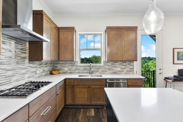 a kitchen with a sink stove and cabinets