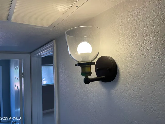 a room with a mirror and a chandelier