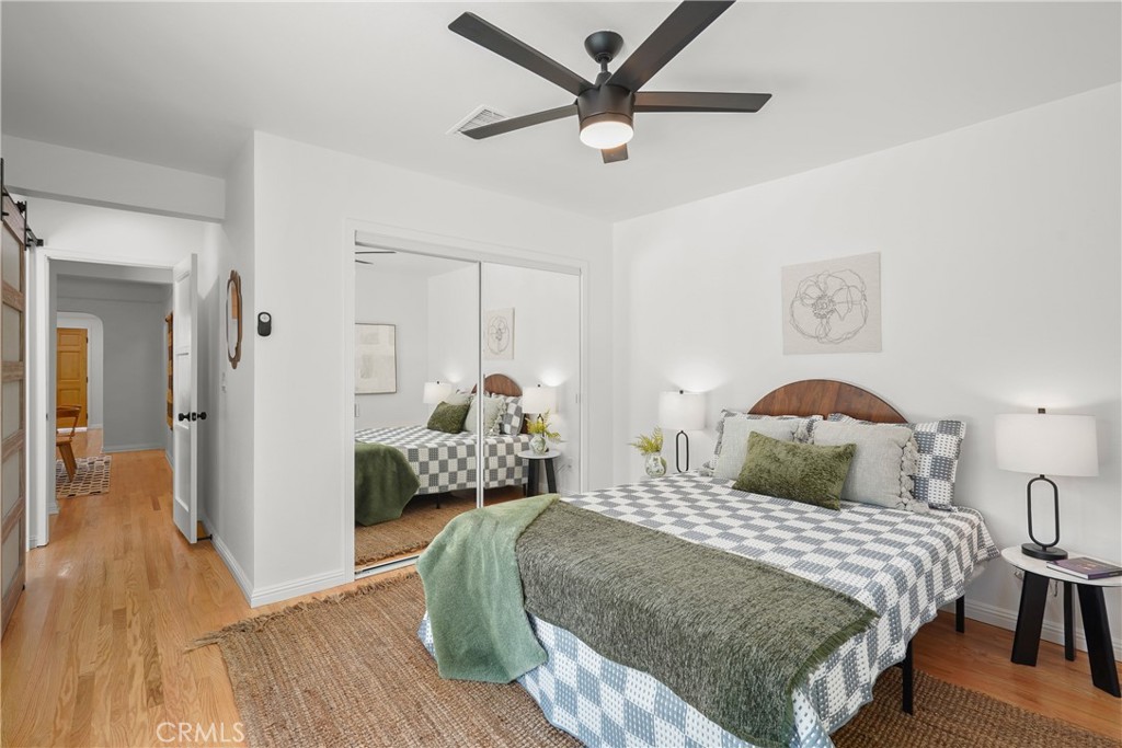 775 Morada Place Altadena, CA 91001 - Photo 12 of 24 a bedroom with a bed and wooden floor