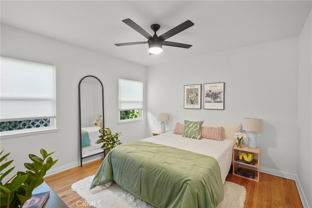 775 Morada Place Altadena, CA 91001 - Photo 15 of 24 a bedroom with a large bed and a potted plant