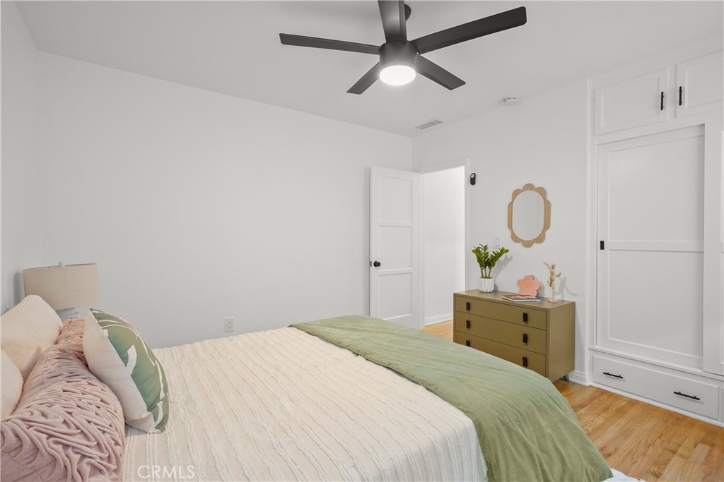 775 Morada Place Altadena, CA 91001 - Photo 16 of 24 a bedroom with a bed and a chandelier