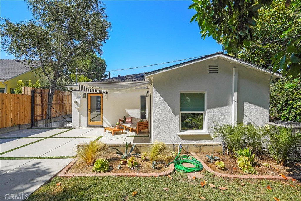 775 Morada Place Altadena, CA 91001 - Photo 22 of 24 a view of a backyard with table and chairs potted plants and a large tree