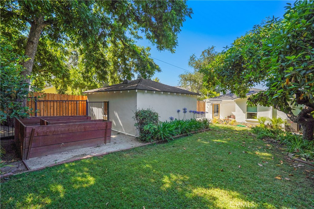 775 Morada Place Altadena, CA 91001 - Photo 24 of 24 a view of a backyard with wooden fence and a large tree