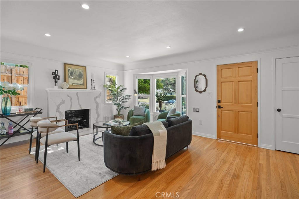 775 Morada Place Altadena, CA 91001 - Photo 4 of 24 a living room with furniture a fireplace and a wooden floor
