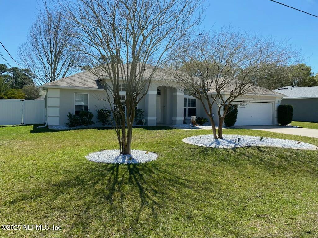 a front view of house with yard and trees