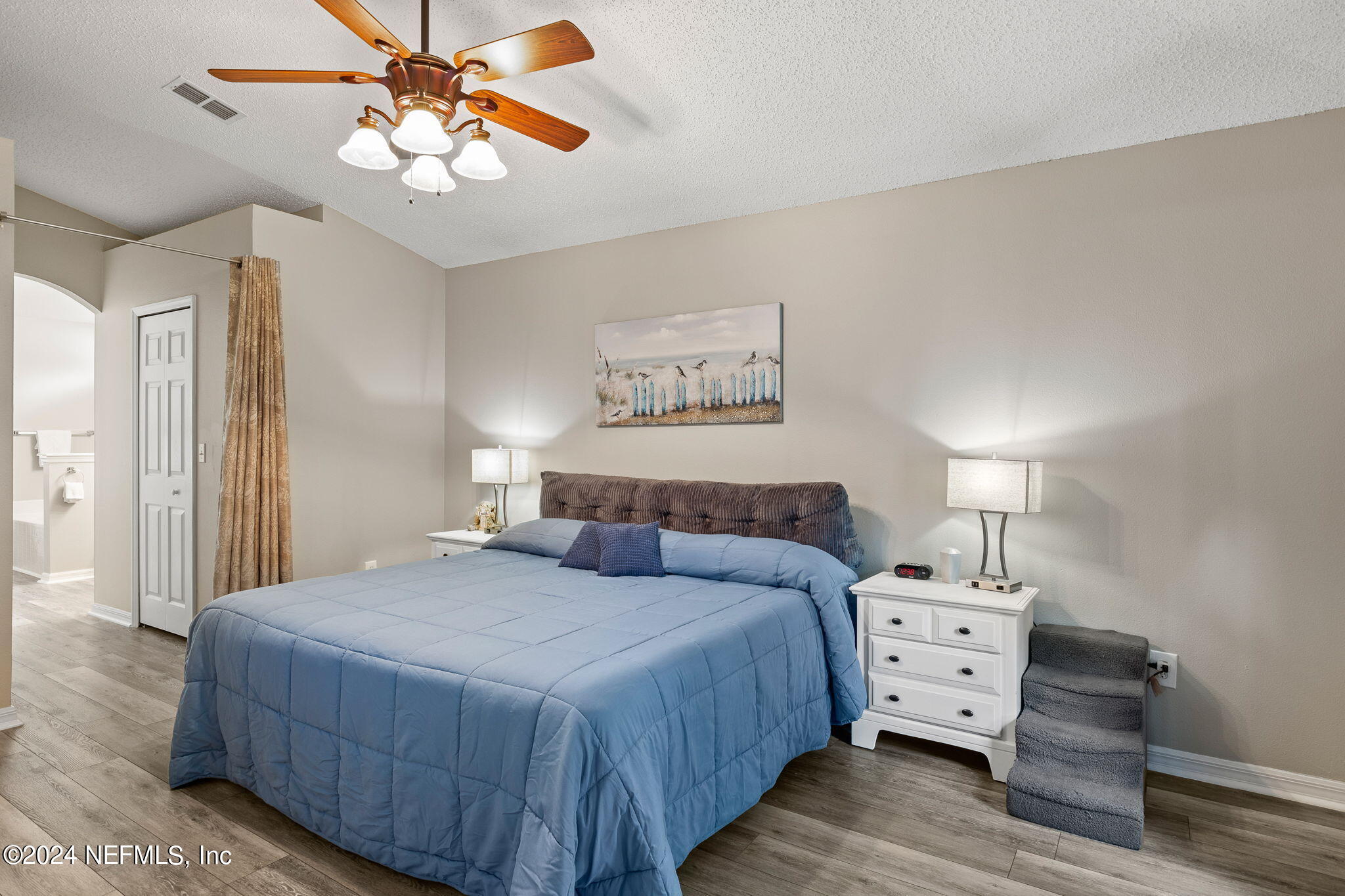 18 Underwick Path Palm Coast, FL 32164 - Photo 11 of 36 a bedroom with a bed and wooden floor