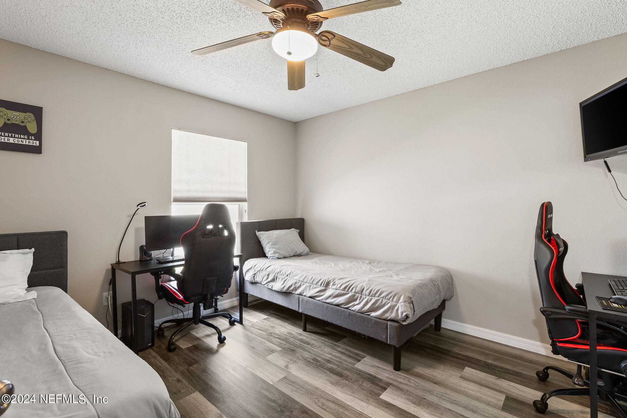 18 Underwick Path Palm Coast, FL 32164 - Photo 17 of 36 a bedroom with a bed wooden floor and table