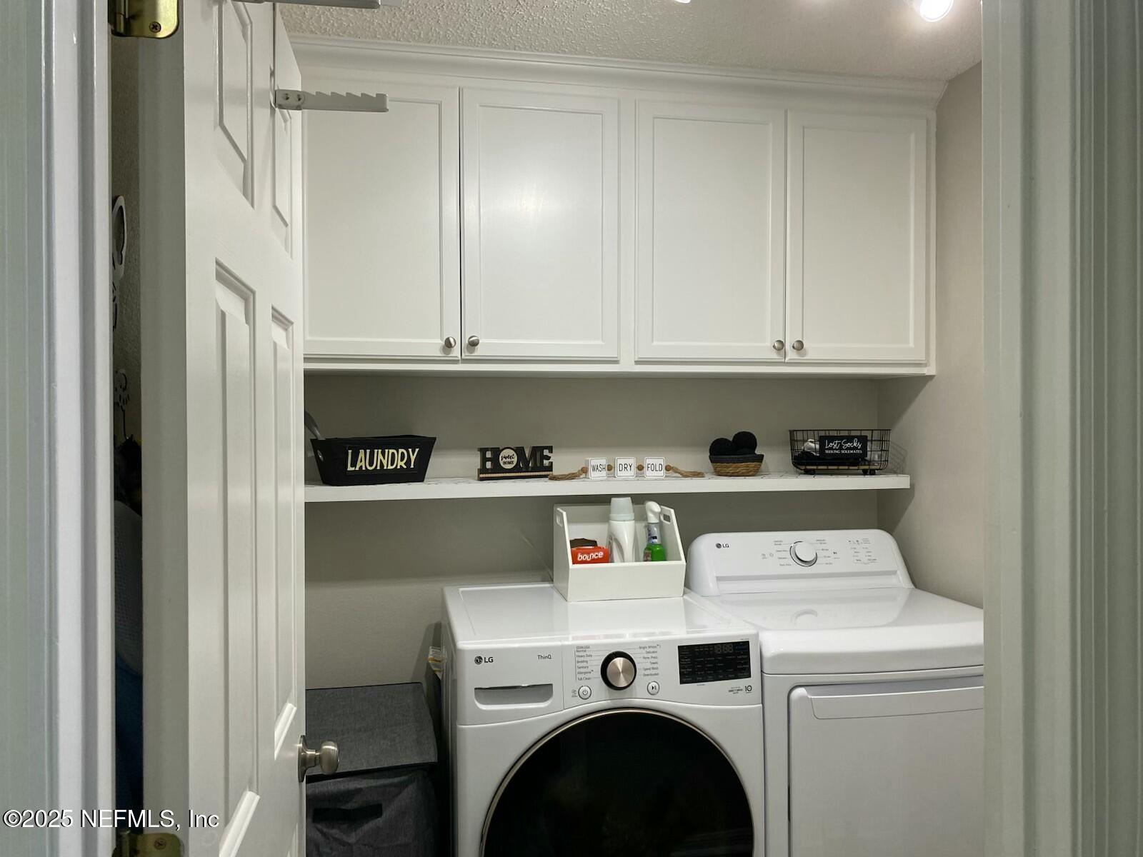 18 Underwick Path Palm Coast, FL 32164 - Photo 23 of 36 a view of washer and dryer with kitchen in the background