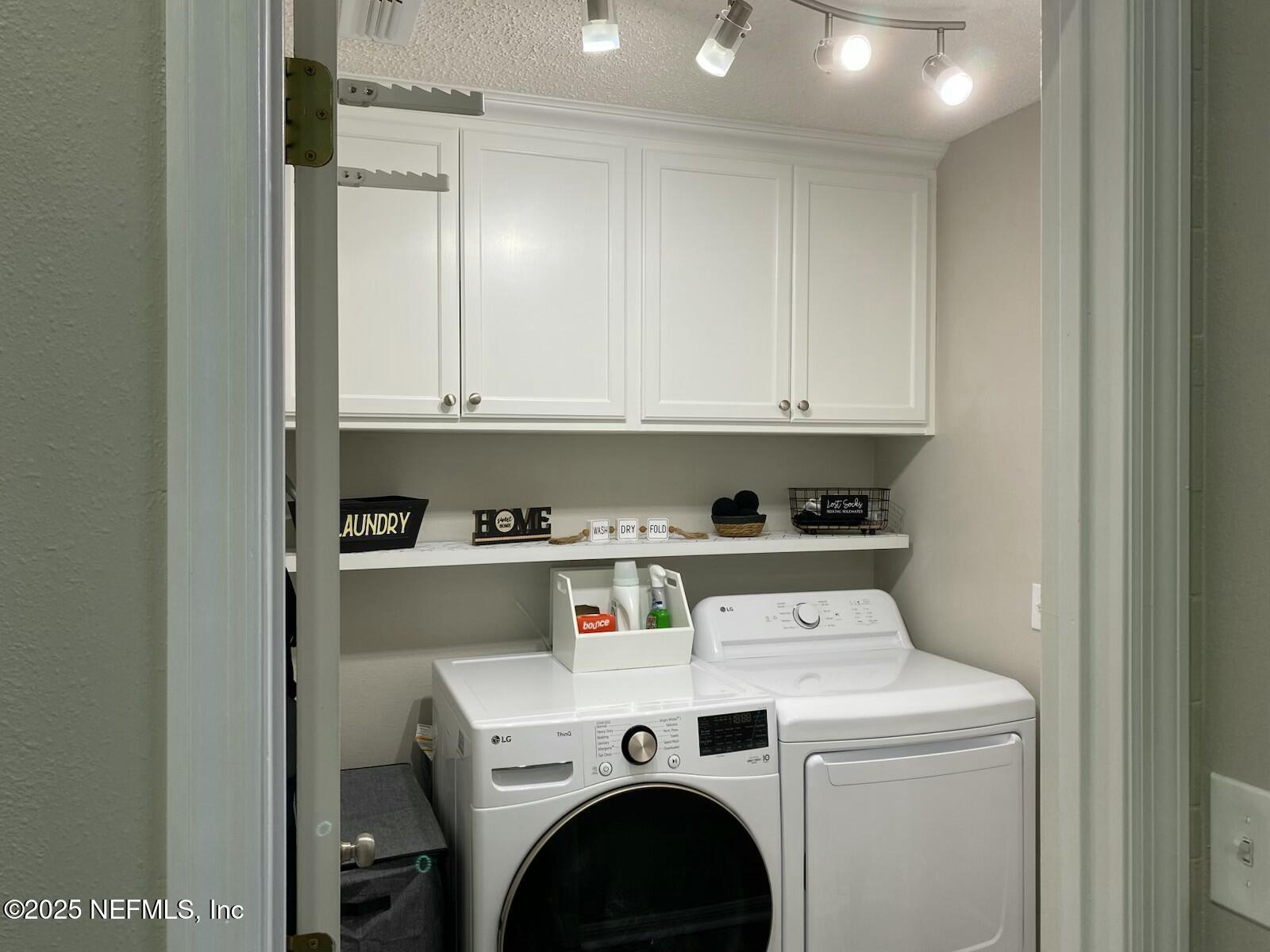 18 Underwick Path Palm Coast, FL 32164 - Photo 24 of 36 a view of washer and dryer with kitchen in the background