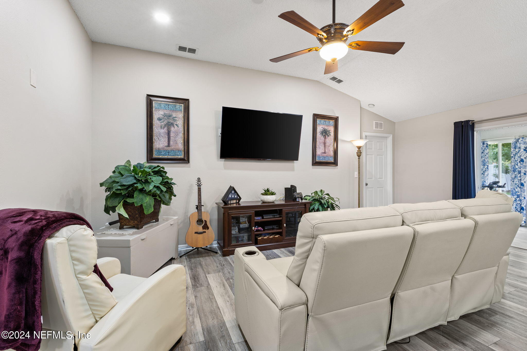 18 Underwick Path Palm Coast, FL 32164 - Photo 5 of 36 a living room with furniture a flat screen tv and a potted plant