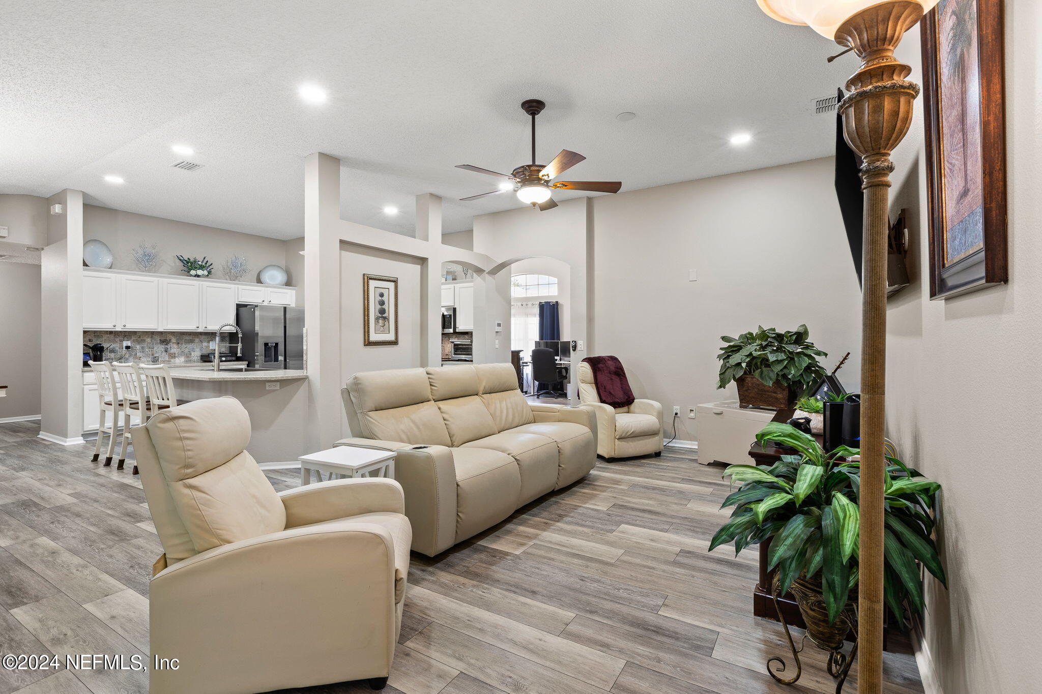 18 Underwick Path Palm Coast, FL 32164 - Photo 6 of 36 a living room with furniture a chandelier and wooden floor