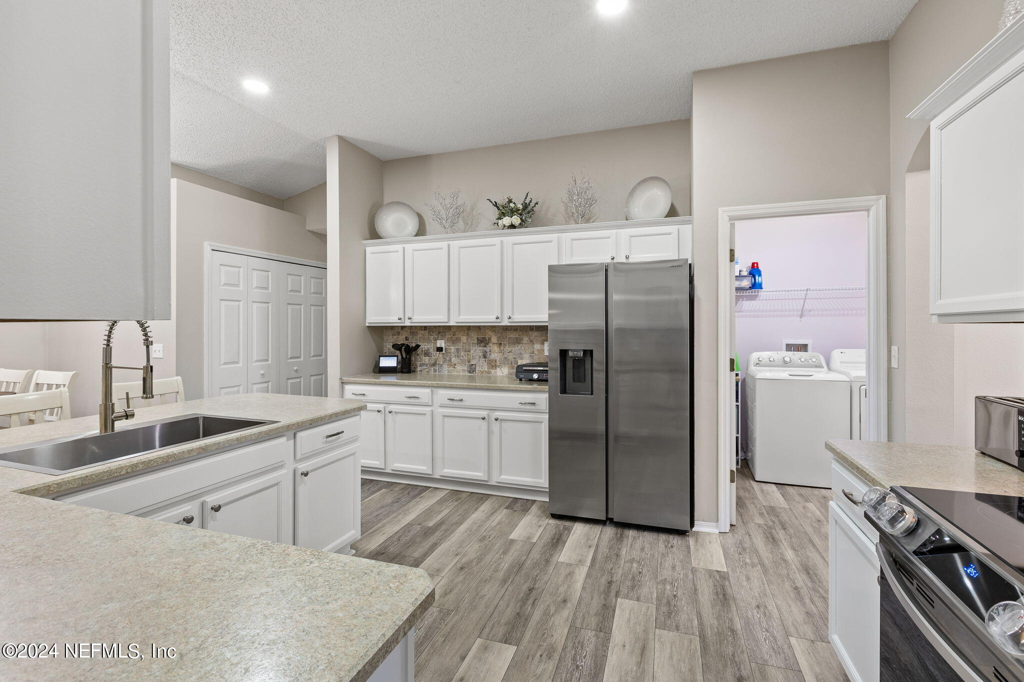 18 Underwick Path Palm Coast, FL 32164 - Photo 8 of 36 a kitchen with a sink stainless steel appliances and cabinets