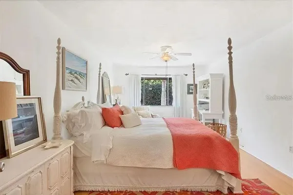 a bedroom with a large bed and a flat screen tv