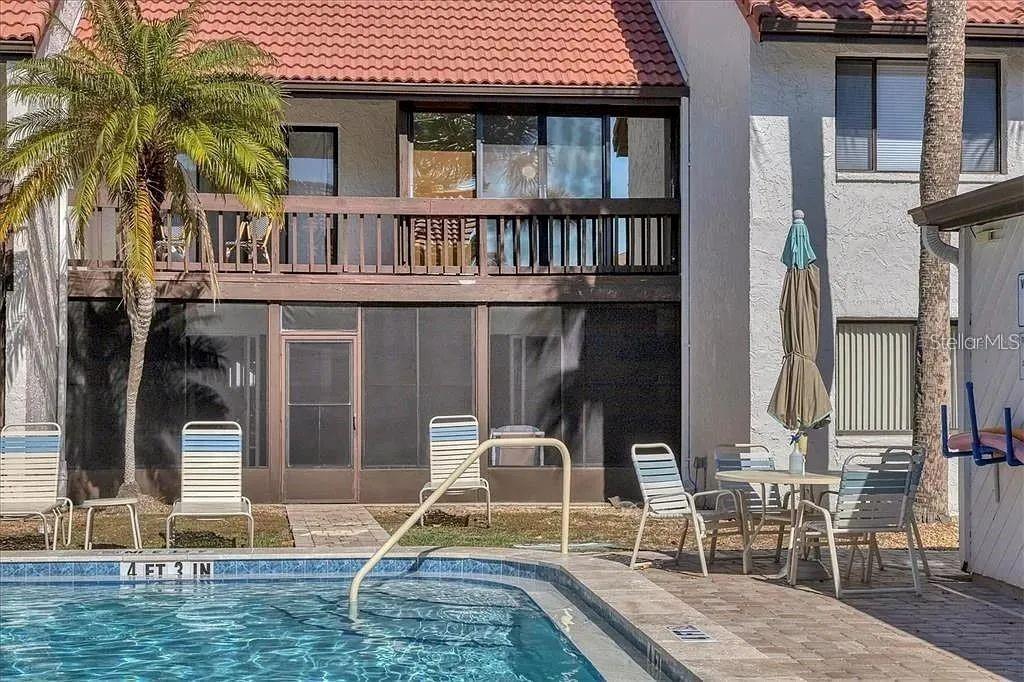 1650 Stickney Point Road, Unit 50202 Sarasota, FL 34231 - Photo 15 of 46 two chairs and a table in a patio