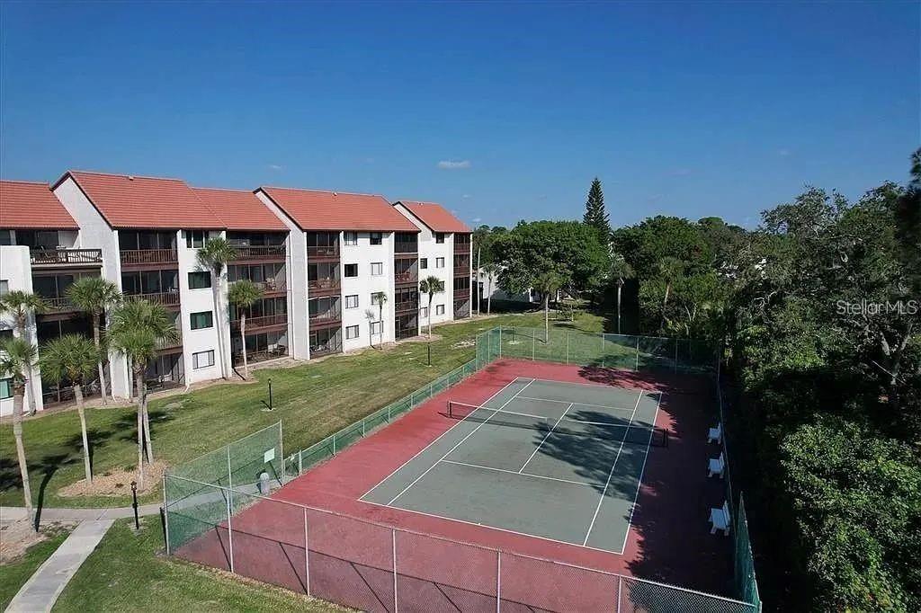 1650 Stickney Point Road, Unit 50202 Sarasota, FL 34231 - Photo 16 of 46 a view of a house with a yard