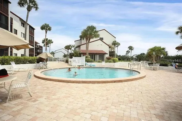 a view of a swimming pool with a patio