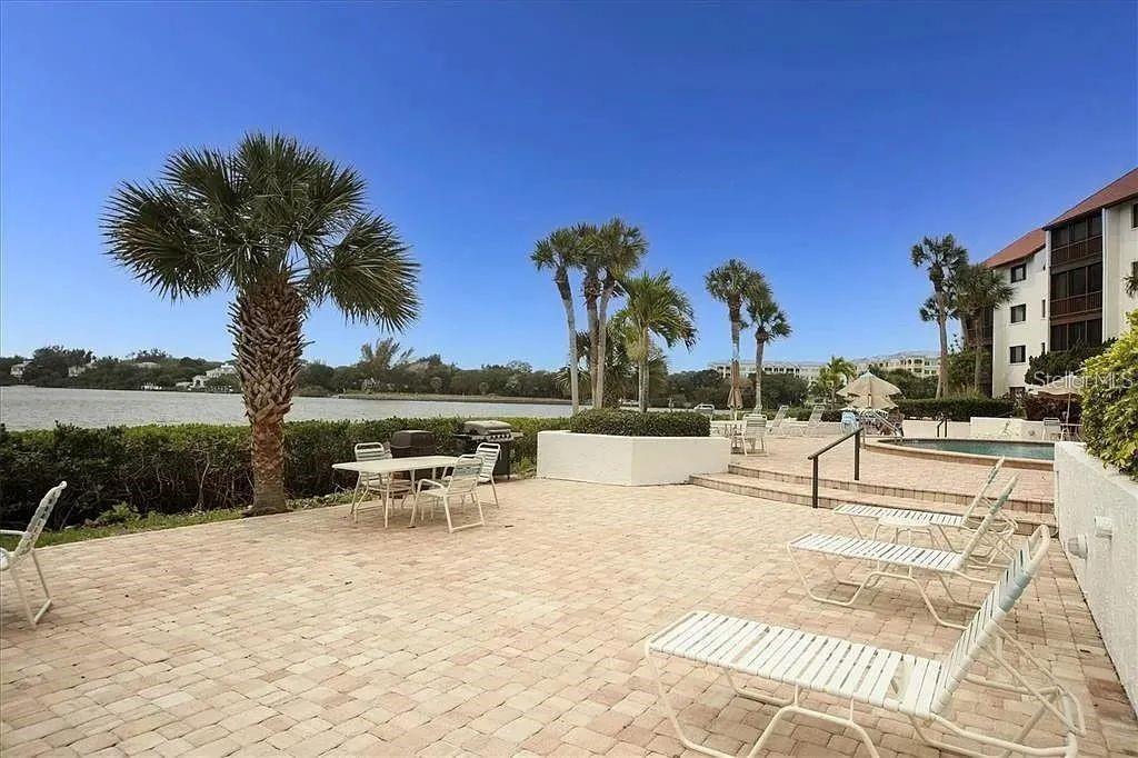 1650 Stickney Point Road, Unit 50202 Sarasota, FL 34231 - Photo 31 of 46 a view of a lake with outdoor seating