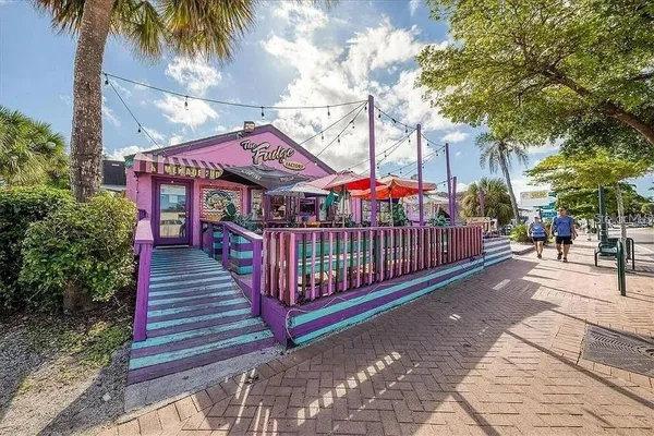a view of swimming pool with palm trees