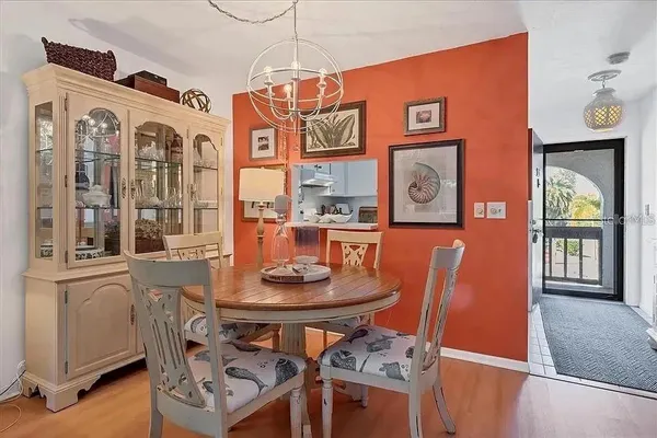 a view of a dining room with furniture large window and wooden floor