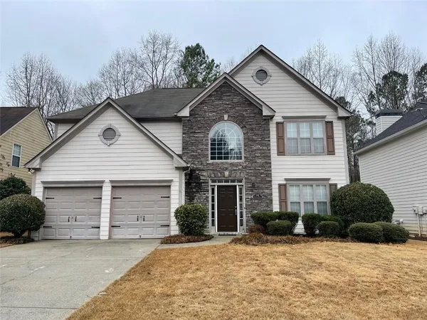 a front view of a house with a yard and garage