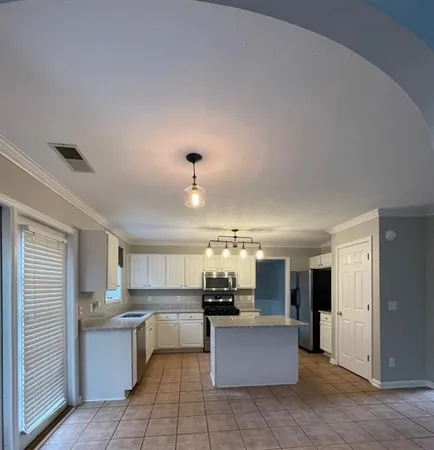 a kitchen with a sink and a stove top oven