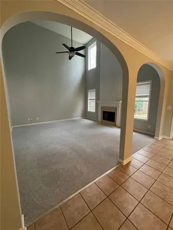 a view of empty room with window and fireplace