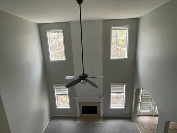 a view of a livingroom with a fireplace and window