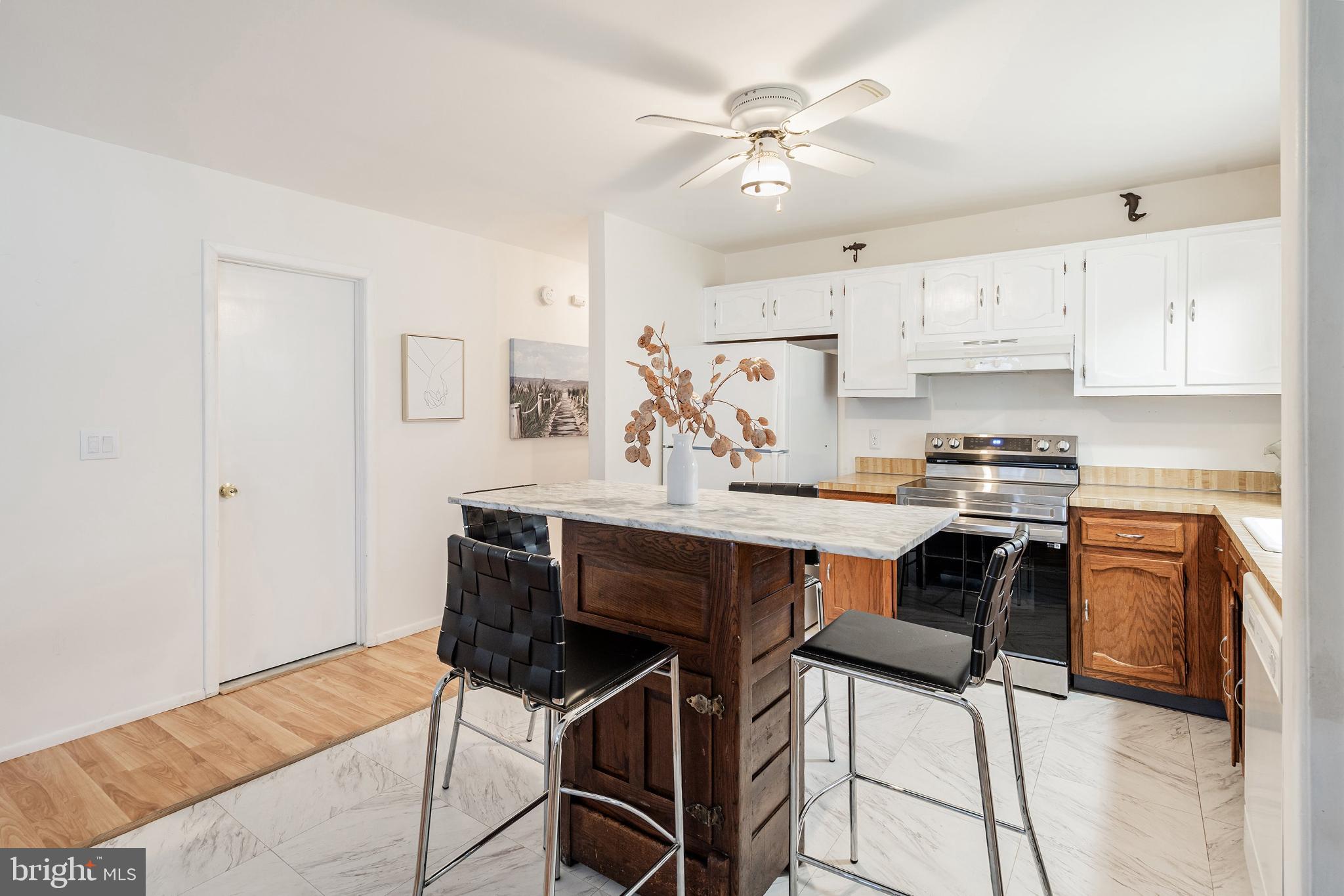 2B Magnolia Road Manahawkin, NJ 08050 - Photo 13 of 37 a kitchen with stainless steel appliances a dining table and chairs