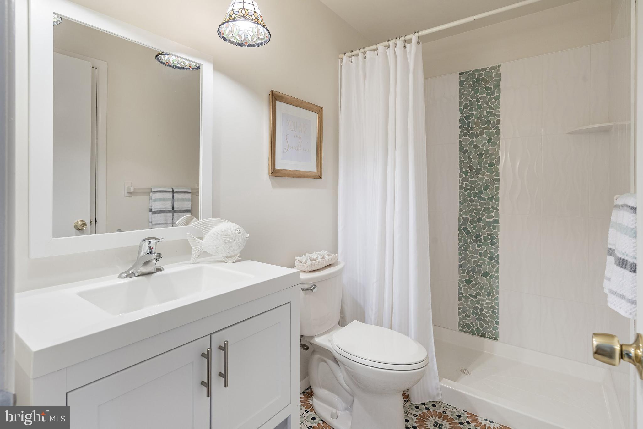 2B Magnolia Road Manahawkin, NJ 08050 - Photo 16 of 37 a bathroom with a sink a toilet and shower