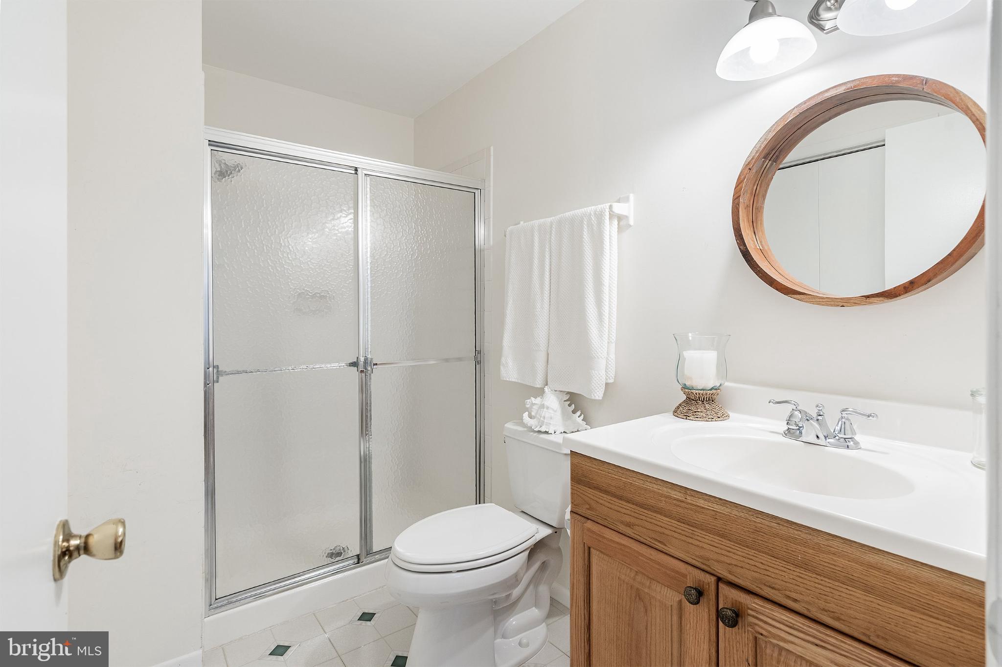 2B Magnolia Road Manahawkin, NJ 08050 - Photo 20 of 37 a bathroom with a sink a toilet and a mirror
