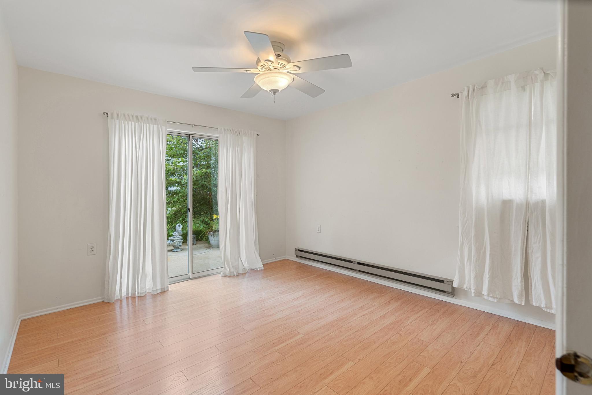 2B Magnolia Road Manahawkin, NJ 08050 - Photo 22 of 37 an empty room with wooden floor fan and windows