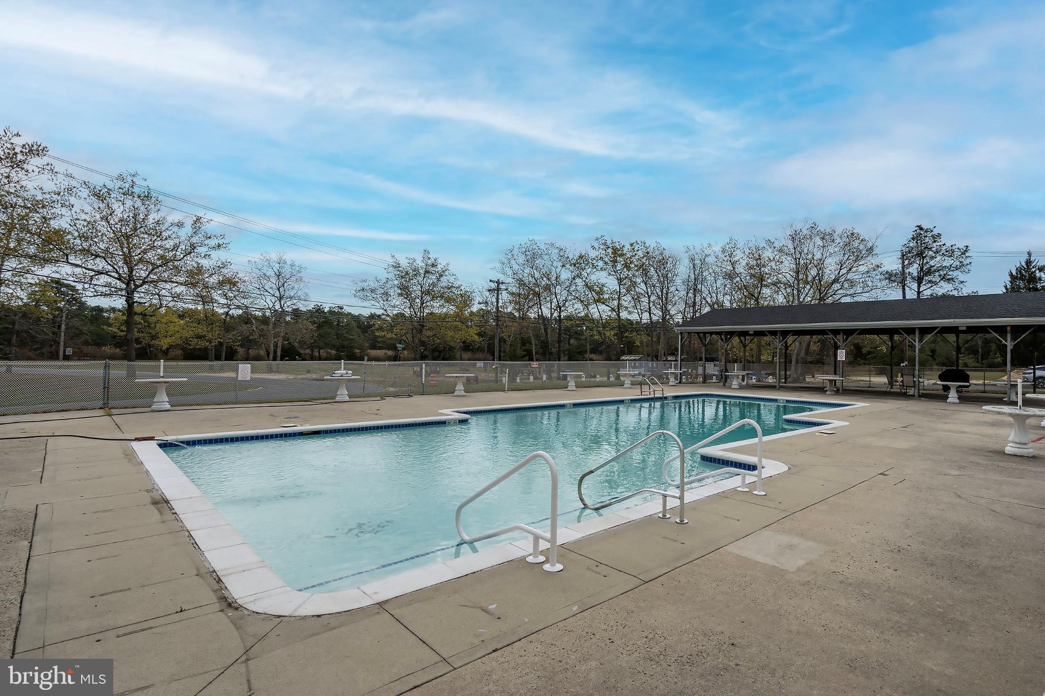 2B Magnolia Road Manahawkin, NJ 08050 - Photo 35 of 37 a view of a swimming pool with a lake view