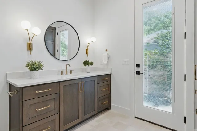 a bathroom with a double vanity sink and a mirror