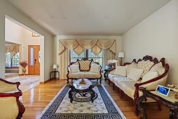 a living room with furniture a rug and a wooden floor