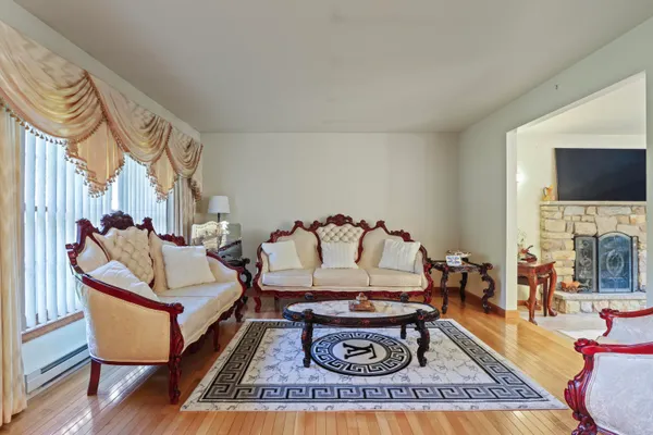 a living room with furniture a rug and a fireplace