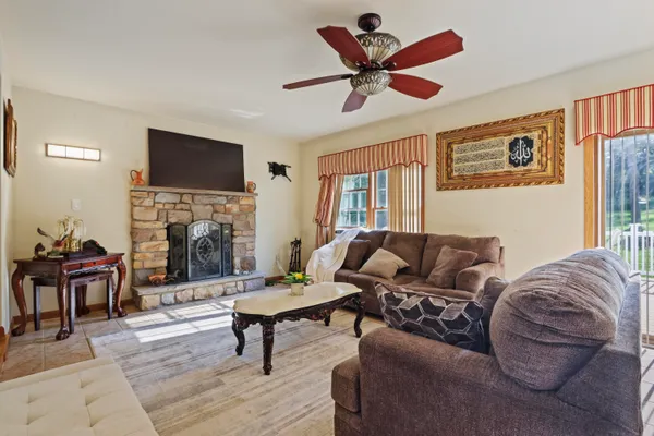a living room with furniture a fireplace and a flat screen tv