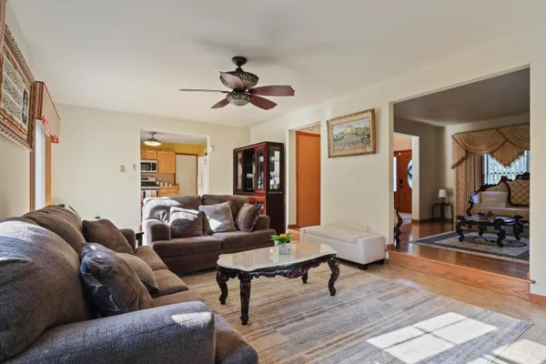 a living room with furniture a rug and a chandelier