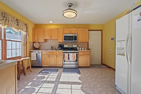 a kitchen with a stove top oven and refrigerator