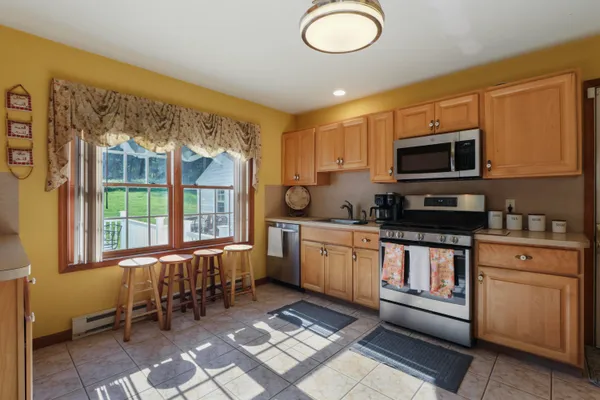 a kitchen with a sink stove and microwave