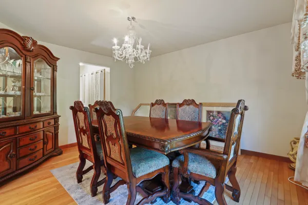 a view of a dining room with furniture and chandelier