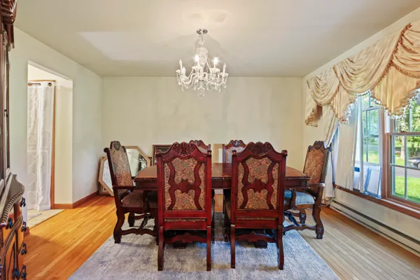 a view of a dining room with furniture and wooden floor