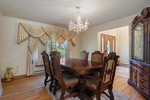 a view of a dining room with furniture and wooden floor