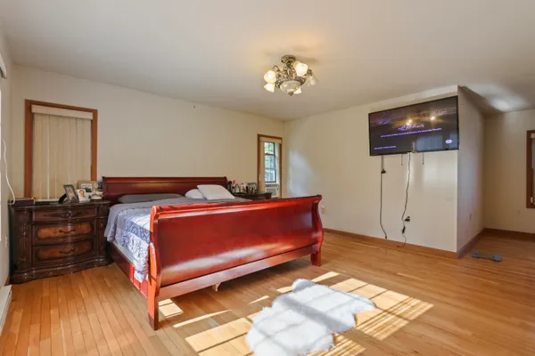 a bedroom with a bed and a chandelier