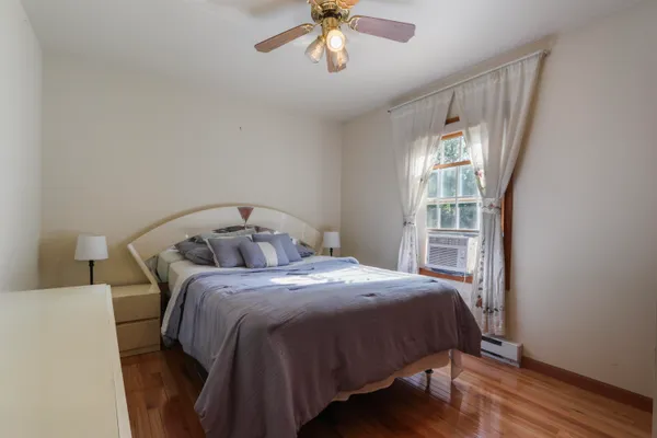 a bedroom with a bed and a window